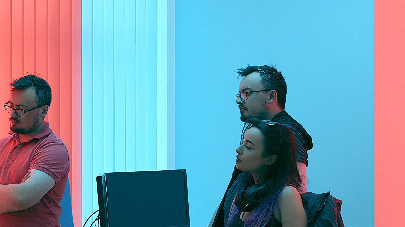 Content By Rico crew reviewing a shoot on a monitor, graded in the studio's red and cyan house look