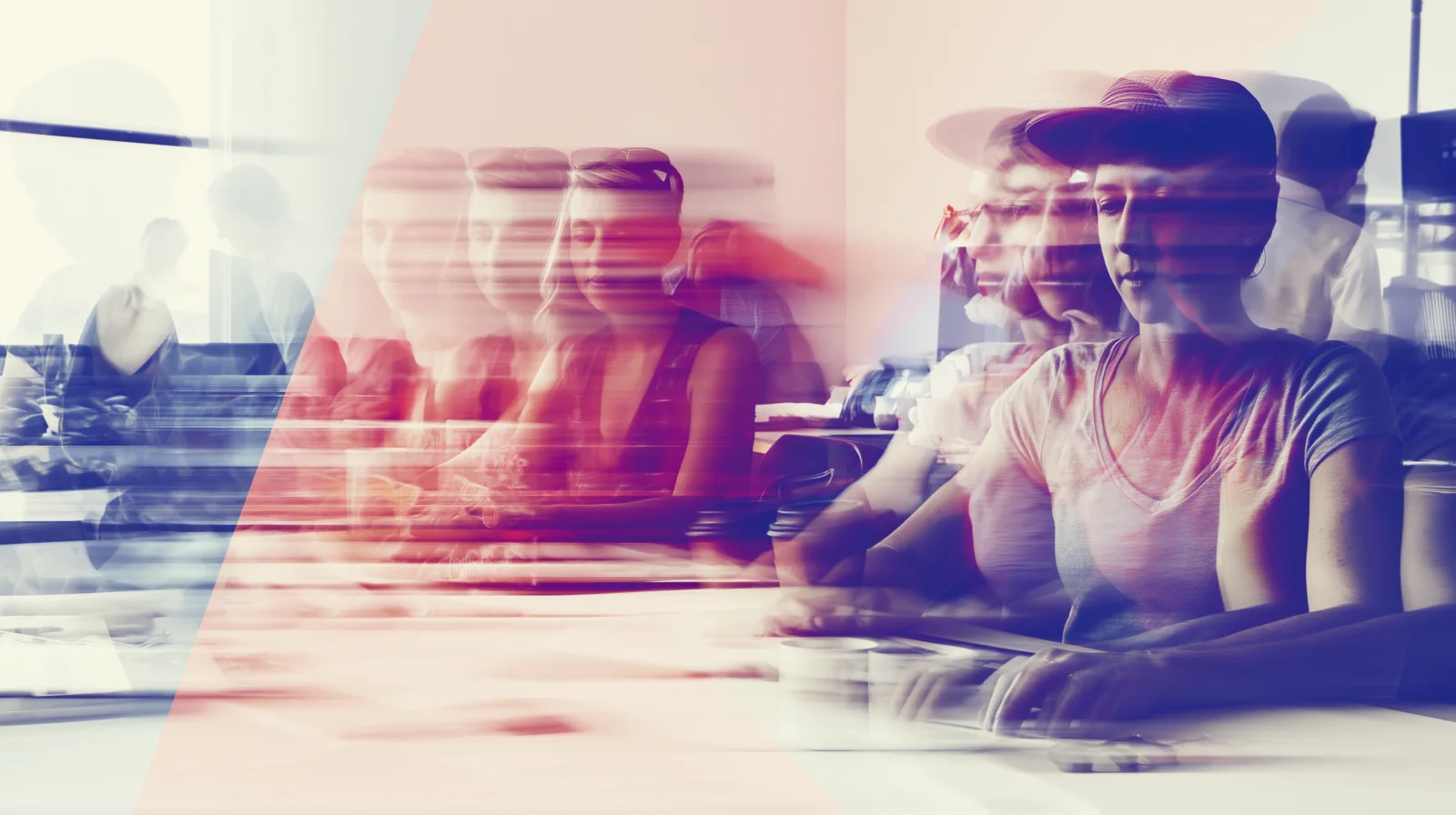 Long-exposure frame of the studio mid-edit, faces smeared into streaks of red and blue